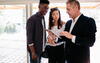 Real estate agent showing house to woman and man